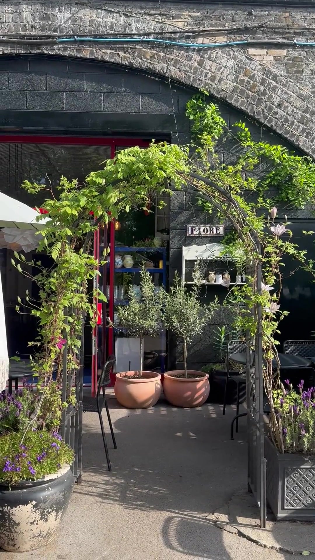 Fiore Truck storefront — charming Italian restaurant entrance with greenery and flowers